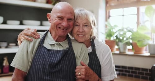 Happy Senior Couple Embrace in Kitchen