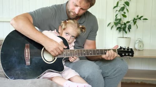Father and Child Play Guitar Together