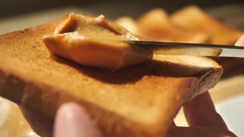 Spreading Peanut Butter on Toast with Knife