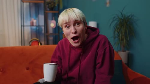 Young Woman Reacts to Shocking News at Home