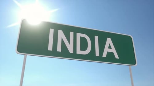 Green Road Sign With India Text Under Bright Sunny Sky