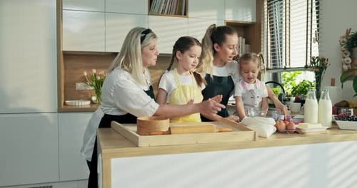 Ältere Oma mittleren Alters in Schürze lehrt Nachkommen Enkelinnen Kneten Machen Hausgemacht