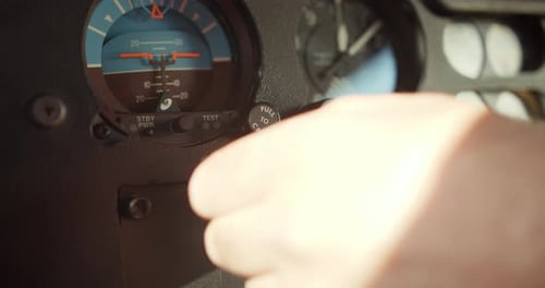 Man Adjusting Gauges and Indicators in Helicopter Cockpit Pilot Performing Preflight Procedure