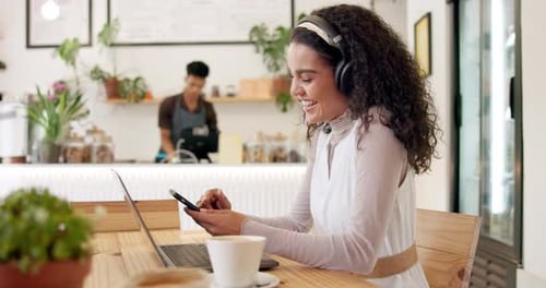 Headphones, laptop and woman on cellphone in coffee shop networking on social media or internet