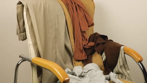Assorted Clothes Piled on Modern Indoor Chair