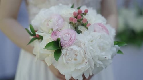 Bride Holding a White and Pink Wedding Bouquet