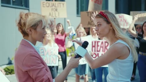 Woman Being Interviewed at a Protest Demonstration