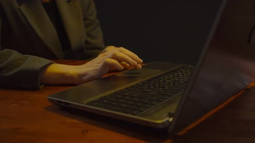 Woman Typing on Laptop Keyboard at Work