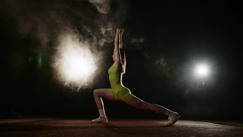 Mujer joven atlética en ropa deportiva negra haciendo estiramientos, ejercicio aeróbico en el gimnasio, Cámara lenta, top