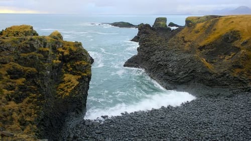 Ocean Waves Crashing on Black Volcanic Cliff Pure Blue Sea Coastline in Iceland