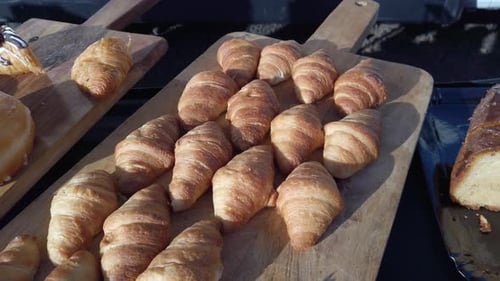 Freshly baked croissants arranged on wooden boards at a buffet