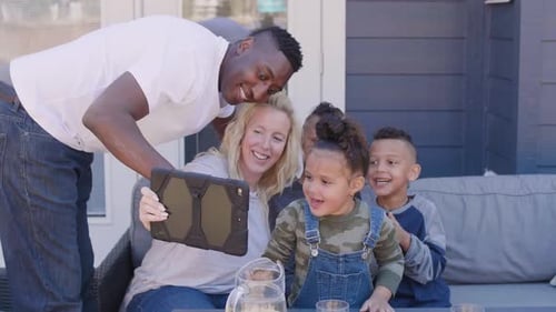 Happy family taking selfie together outdoors