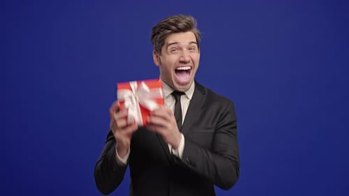 Mature Businessman Boss Man Got Gift Present Box On Blue Office Background