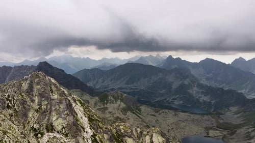 Majestic mountains rise under dramatic skies in a captivating landscape