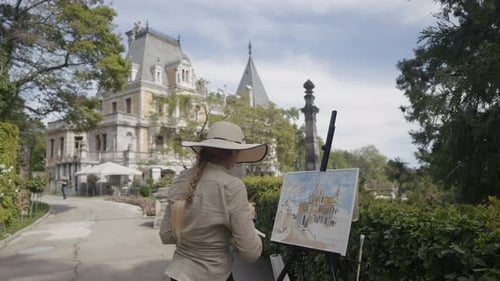 The Painter Paints a Picture of the Fortress Action Rear View of an Elegant Woman Artist in a Hat