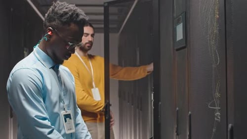 Technicians Working in Modern Data Center Server Room