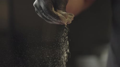 Closeup Slow Motion Video of Chef's Hand Peppering Meat