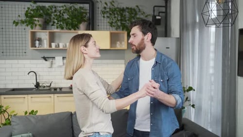 Loving Couple Dancing Affectionately in Modern Home
