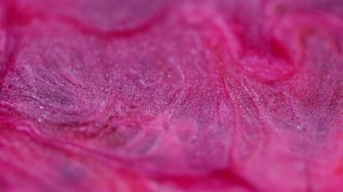 Swirling Pink and Purple Glitter Liquid Close Up