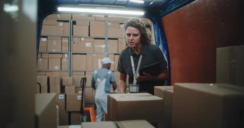 Logistics Warehouse Female Manager with Digital Tablet Scanning Cardboard Boxes Using Barcode