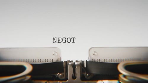 Old mechanical typewriter typing Negotiation in a close-up view.