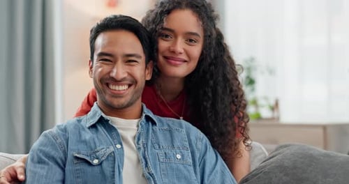 Cheerful Couple Smiling on Living Room Sofa