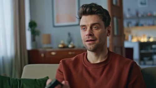 Closeup Man Watching Show on Tv at Home Portrait Smiling Guy Switching Channel