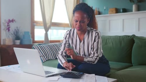 Concerned Woman Does Finances on Laptop at Home