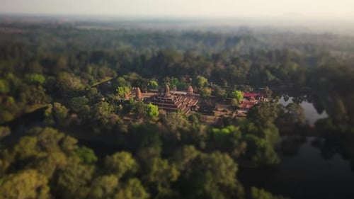 Angkor Wat temple, Bakong, tilt shift effect. Nested in the mystic Cambodian jungle, aerial rotation