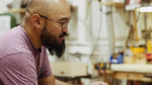 Smiling Male Carpenter Working with Wood in Carpentry Workshop 3539 Years
