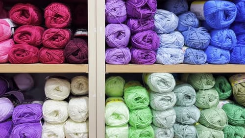 Colorful Balls of Wool on the Shelf Different Balls of Yarn of Different Colors Slow Motion
