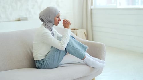 Woman in Hijab Sitting Alone Contemplating