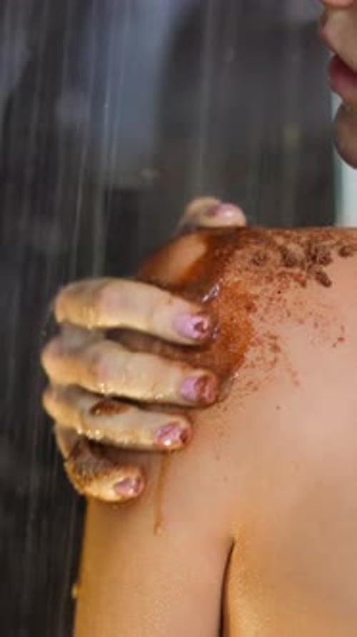 Woman Exfoliating Skin in Shower, Close-up