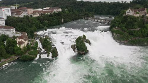 Aerial view of the stunning Rhine Falls with water cascading over rocks in Switzerland