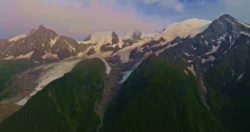 Drone Flies Over Green Picturesque Valley with Mountains in the Background High Mountains Famous