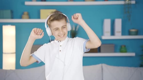 Teen Boy Dancing to Music with Headphones On