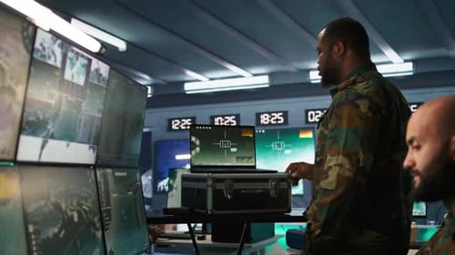 Men Examining Computer Screens in Tech Workplace