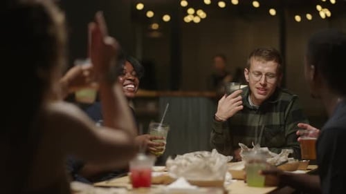 Merry Friends Meeting In Restaurant Happy Young Adult Multiethnic People Communicating And Toasting