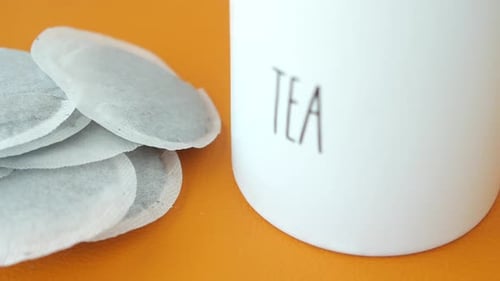 Tea Bags and Yellow Color Mug on Table