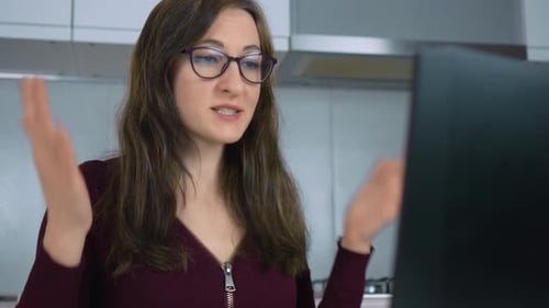 Woman Talking on Video Call in Kitchen