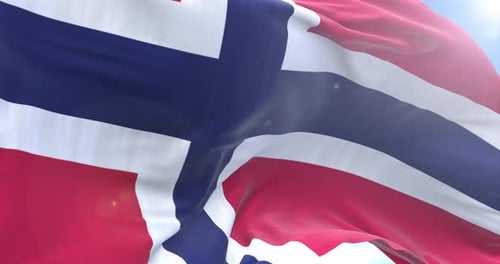 Waving Norwegian Flag Against Bright Blue Sky