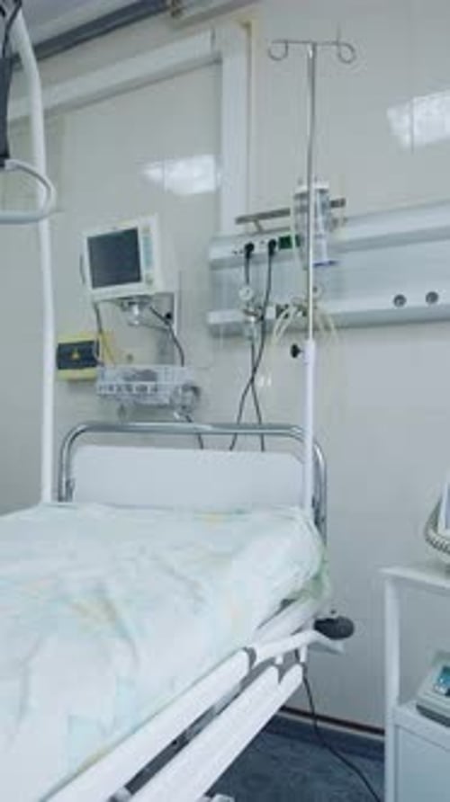 New hospital bed and equipment in a clean room. Empty intensive care room.