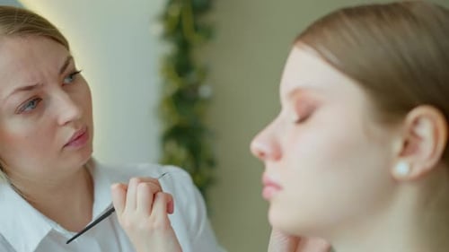 Makeup Artist Work in Her Beauty Studio Portrait of Woman Applying By Professional Make Up Master