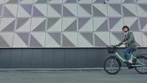 Woman Riding Her Bicycle Along Street