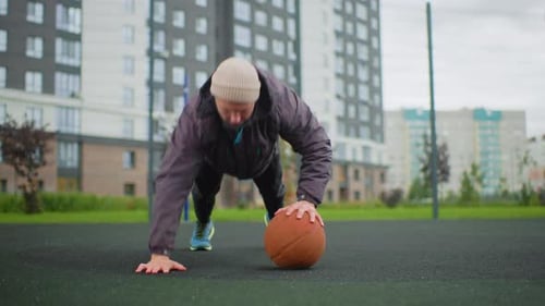 Man Practicing Drills on Rainy Asphalt Surface Dedicated Street Athlete Performs Strength and Skill