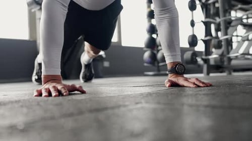 Focused Young Man Performing PushUps in a Modern Gym