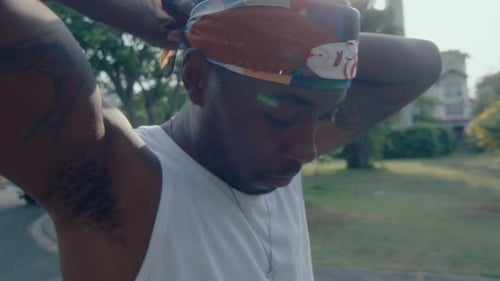Young Man Tying a Bandana on Head