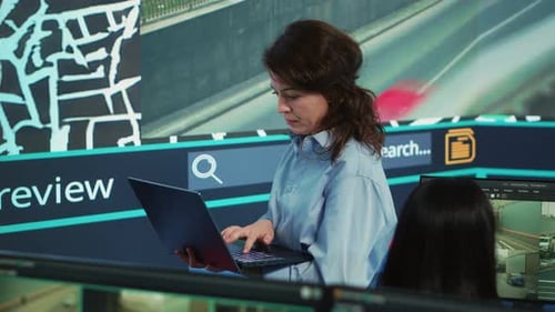 Woman Uses Laptop in High Tech Control Center