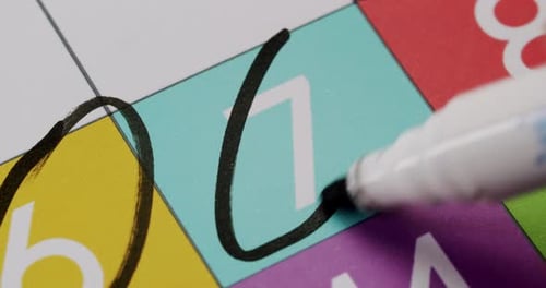 Black Marker Circling Colorful Calendar Dates