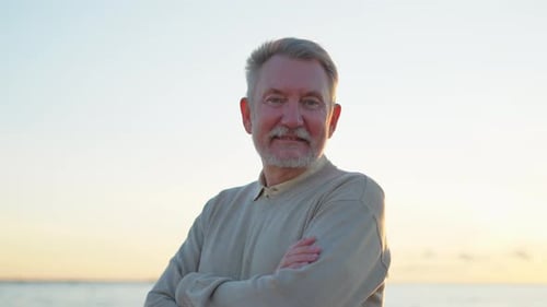 Smiling Senior Man Standing Near the Beach